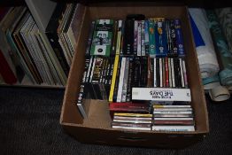 A box full of compact discs and DVDs and a small amount of LPs, something for everyone!