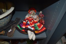 A Mexican styled doll and a similar 1950's plastic wind up native American Indian toy