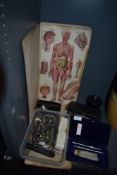 A selection of medical and surgical equipment including biological chart and operating instruments