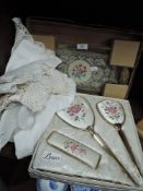A selection of vintage doilies and cloths and a boxed dressing table set and tray.