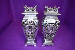 A pair of electroplated mantle vase or urns early 20th century having pierced bodies