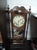An early 20th century American style wall clock having carved and inlaid detailing.