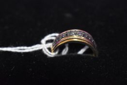 A 9ct gold band ring having a double row of black diamond chips, size W & approx 2.9g