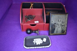 A modern desk top tidy with two Victorian photographs a tortoise shell miniature guitar and a set of