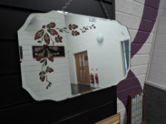 An art deco bevel edged mirror with floral detail