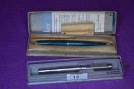 Two Parker fountain pens. A Parker 25 Flighter stainless steel cartridge pen and a Parker 45 in