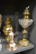 A small proportioned Victorian oil lamp with brass base and twisted well with similar brass style