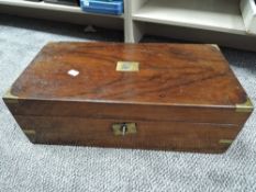 An antique mahogany writing slope having internal compartments and two ink wells.