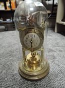 An anniversary clock having glass dome and skeleton body