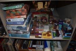 A large assortment of vintage and modern games and jigsaws.