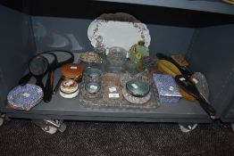 A selection of dressing table items including ebony brushes and chintz style container