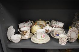 A selection of tea cups and saucers including nursery rhyme printed and Colclough