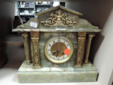 A marble mantel clock with green pillar design by W H Skinner of St Leonards on sea