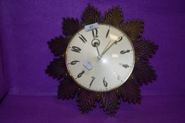 A vintage mid century starburst wall clock by Metamec
