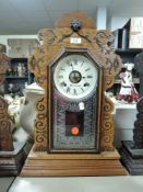 An Ansonia Clock Co, America 8 day gingerbread clock