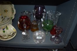 A selection of various glass wares including colour brandy glasses and dinner bells