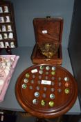 A replica portable inclining sundial with case and a game of peg marbles