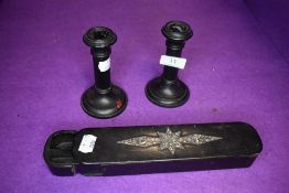 A pair of ebony candle sticks by Maddens and a papier mache pen container with mother of pearl