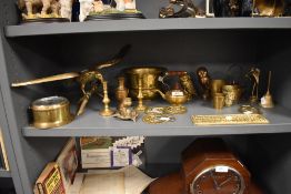 A selection of brass cast figures and candle sticks also a port hole style clock by Sestrel