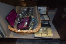 An assortment of cutlery including bone handled knives and forks and more.