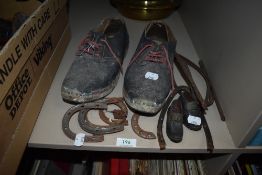 A pair of vintage clogs and similar dolls pair also a collection of shoe protecting metal ware.
