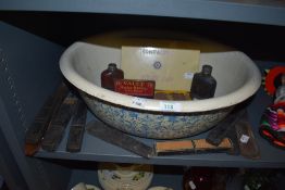 A large papier mache wash bowl hand decorated with several sets or cut throat and similar razors