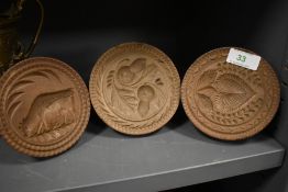 Three farm house biscuit molds or press decorated with harvest and cattle scenery