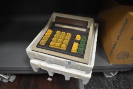 A vintage calculator by Rapidman 1212 in case