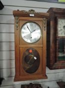 A wood framed wall clock with pendulum