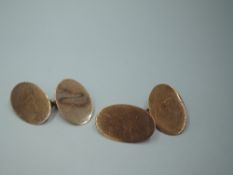 A pair of 9ct rose gold cufflinks of plain oval disc form with chain connectors, approx 5g
