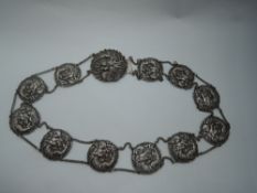 A Japanese Meiji period silver belt bearing the Jungin mark having eleven circular panels and