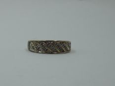 A 9ct gold band ring having a diamond chip panel to front, size Q & approx 3.7g