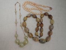 A string of baroque style cultured pearls, over sized simulated pearl and yellow wire necklace and a