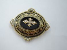 A Victorian yellow metal oval mourning brooch/pendant with clip attachment, having black onyx