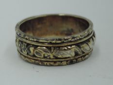 A white and yellow metal band ring having moulded decoration, no marks, size R/S & approx 5.9g