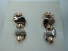 A pair of 9ct white and rose gold stud earrings having decoartive articulated drops, approx 1.8g