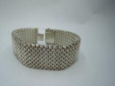 A silver bracelet of woven form having concealed clasp, approx 84g