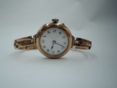 A vintage 9ct rose gold wrist watch having Arabic numeral dial and gilt minute dots to white