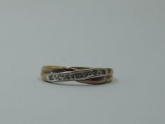 A 9ct gold band ring having diamond chip decoration to moulded cross detail, size P & approx 2.1g
