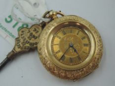 A lady's small yellow metal key wound pocket watch stamped 18K having Roman numeral dial on engraved