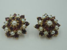 A pair of garnet and seed pearl multi layer daisy cluster clip earrings in yellow metal mounts