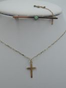 A yellow metal bar brooch stamped 9ct having a central opal and a 9ct gold cross pendant on a yellow
