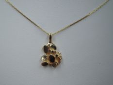 An American gold nugget pendant stamped 14K on a fine yellow metal chain stamped 14k, approx 27' &