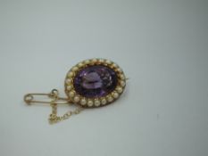 An oval amethyst and seed pearl brooch in a yellow metal mount stamped 15ct, approx 3.9g