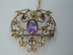 An Edwardian yellow metal pendant/brooch stamped 9ct having amethyst and seed pearl decoration in