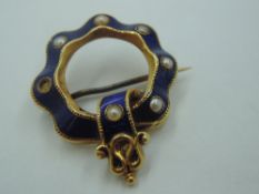 A Victorian yellow metal garter brooch having blue enamel and seed pearl decoration, no marks