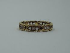 An 18ct gold eternity ring of shaped form having paste stones, size O & approx 3.4g