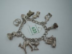 A silver charm bracelet with padlock clasp having eight white metal charms including camel, emu,