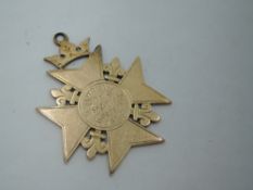 A Victorian yellow metal medalion having presentation inscription regarding a military team match,