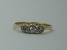 A diamond trilogy ring, total approx 0.128ct in an illusionary setting to knife blade shoulders on a